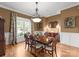 Dining room with hardwood floors, a large window, and an elegant chandelier at 13215 Claysparrow Rd, Charlotte, NC 28278