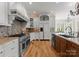 Well-equipped kitchen with stainless steel appliances, custom cabinets, and a tiled backsplash at 13215 Claysparrow Rd, Charlotte, NC 28278