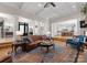 Open-concept living room with coffered ceilings, hardwood floors, and access to the kitchen at 13215 Claysparrow Rd, Charlotte, NC 28278