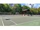 Well-maintained tennis court with covered seating area, perfect for sports enthusiasts and outdoor enjoyment at 13215 Claysparrow Rd, Charlotte, NC 28278