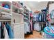Well-organized walk-in closet featuring custom shelving, hanging rods, and storage drawers for clothing at 13215 Claysparrow Rd, Charlotte, NC 28278