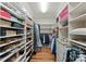 Spacious walk-in closet boasts custom shelving, providing ample storage for shoes, clothing, and accessories at 13215 Claysparrow Rd, Charlotte, NC 28278