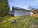 Lush backyard featuring a stone fire pit and the exterior of the home at 134 Burke Cir, Mooresville, NC 28115