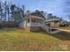 Charming single-story home featuring a welcoming front porch and landscaped front yard at 134 Burke Cir, Mooresville, NC 28115