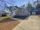 Single-story home featuring a welcoming front porch, landscaped yard, and long driveway at 134 Burke Cir, Mooresville, NC 28115
