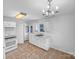 Well-lit kitchen featuring white cabinets, tiled floors, and modern appliances including a stove and oven at 134 Burke Cir, Mooresville, NC 28115