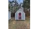Outdoor shed with siding and maroon door offering extra storage space in backyard at 134 Burke Cir, Mooresville, NC 28115