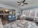 Inviting living room with a large rug, wooden coffee table, and ample natural light streaming through large windows at 1400 Huntcliff Dr, Waxhaw, NC 28173