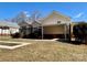 Backyard view of the house featuring a deck, carport, and landscaped yard at 1420 28Th Sw St, Hickory, NC 28602