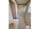 Bathroom featuring a glass door shower, toilet, vanity with drawers, and a window at 1420 28Th Sw St, Hickory, NC 28602