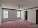 Bedroom with two windows, ceiling fan and pink carpet at 1420 28Th Sw St, Hickory, NC 28602