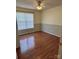 This bedroom has hardwood floors, one window and striped wainscoting at 1420 28Th Sw St, Hickory, NC 28602