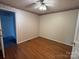 Bedroom with hardwood floors, ceiling fan and view to hall with blue carpet at 1420 28Th Sw St, Hickory, NC 28602