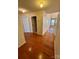 Hallway featuring gleaming hardwood floors, bright lighting, and access to various rooms in the home at 1420 28Th Sw St, Hickory, NC 28602