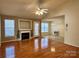 Open-concept living room with a cozy fireplace, hardwood floors, and natural light from multiple windows at 1420 28Th Sw St, Hickory, NC 28602