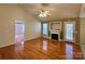 Bright living room with hardwood floors, fireplace, ceiling fan, and access to other rooms at 1420 28Th Sw St, Hickory, NC 28602