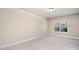 Empty bedroom featuring neutral walls, trim molding, baseboards and a window with bright sunlight at 15411 Guthrie Dr, Huntersville, NC 28078