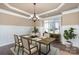 Formal dining room featuring classic wainscoting, modern lighting, and a large window with natural light at 15411 Guthrie Dr, Huntersville, NC 28078