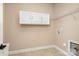 Empty laundry room with tile flooring, white cabinets, and wire shelving at 15411 Guthrie Dr, Huntersville, NC 28078