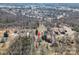 Aerial view of a house nestled in a wooded neighborhood with mature trees and surrounding roads at 1547 Kings Rd, Shelby, NC 28150