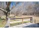 Wooden deck overlooks a spacious backyard with mature trees, perfect for relaxation at 1547 Kings Rd, Shelby, NC 28150