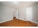 Bedroom featuring hardwood floors and an open closet door, creating a simple and inviting atmosphere at 1547 Kings Rd, Shelby, NC 28150