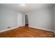 Bedroom featuring hardwood floors and an open closet door, creating a simple and inviting atmosphere at 1547 Kings Rd, Shelby, NC 28150