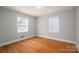 Bedroom featuring hardwood floors and two windows providing natural light, creating a simple and inviting atmosphere at 1547 Kings Rd, Shelby, NC 28150