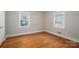 Bedroom featuring hardwood floors and two windows providing natural light, creating a simple and inviting atmosphere at 1547 Kings Rd, Shelby, NC 28150