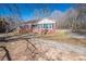 Charming brick home with a well-maintained front yard, a paved walkway, and mature trees at 1547 Kings Rd, Shelby, NC 28150
