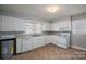 Functional kitchen with white cabinets, a window, and essential appliances at 1547 Kings Rd, Shelby, NC 28150