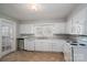 Functional kitchen with white cabinets, a window, and essential appliances at 1547 Kings Rd, Shelby, NC 28150