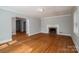 Spacious living room with hardwood floors, a fireplace, and arched doorways, offering classic charm at 1547 Kings Rd, Shelby, NC 28150