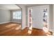 Living room featuring hardwood floors, fresh paint, and a bright front door at 1547 Kings Rd, Shelby, NC 28150