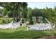 Charming outdoor wedding venue featuring white chairs, draped fabrics, flower accents, and a peaceful lake backdrop at 2069 Landry Ln # 233, Rock Hill, SC 29732