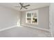 Well-lit bedroom with a ceiling fan and a large window, offering a serene atmosphere at 2069 Landry Ln # 233, Rock Hill, SC 29732