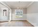A dining room with hardwood floors, wainscoting, and a modern chandelier at 2069 Landry Ln # 233, Rock Hill, SC 29732