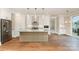 Eat-in kitchen featuring modern white cabinets, large central island, and hardwood floors at 2069 Landry Ln # 233, Rock Hill, SC 29732