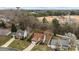 This aerial view showcases the property's proximity to a neighborhood baseball field and surrounding trees at 207 Pebble Creek Xing, Fort Mill, SC 29715