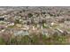 An aerial view reveals the home nestled in a neighborhood with abundant trees and well-maintained lawns at 207 Pebble Creek Xing, Fort Mill, SC 29715
