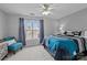 Bright bedroom with a ceiling fan, large window with curtains, and a comfortable bed with stylish linens at 207 Pebble Creek Xing, Fort Mill, SC 29715