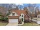 Charming two-story home with a well-manicured lawn and brick accents creating curb appeal at 207 Pebble Creek Xing, Fort Mill, SC 29715