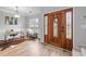 Inviting foyer showcasing a decorative front door, stylish light fixture, and hardwood floors at 207 Pebble Creek Xing, Fort Mill, SC 29715