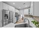 Bright kitchen features stainless steel appliances, quartz countertops, tiled backsplash, and modern white cabinets at 207 Pebble Creek Xing, Fort Mill, SC 29715