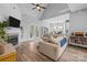 Cozy living room featuring a fireplace, comfortable seating, and an open layout to the kitchen and dining area at 207 Pebble Creek Xing, Fort Mill, SC 29715