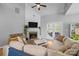 Comfortable living room featuring a fireplace, access to the backyard, and plenty of natural light at 207 Pebble Creek Xing, Fort Mill, SC 29715