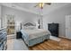 Serene primary bedroom with two large windows, wood flooring, and tasteful decor at 207 Pebble Creek Xing, Fort Mill, SC 29715