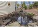 Picturesque backyard pond featuring natural stone borders and tranquil water feature at 207 Pebble Creek Xing, Fort Mill, SC 29715
