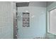 Stylish shower featuring blue tiled walls, decorative patterned tile, and a built-in seat at 207 Pebble Creek Xing, Fort Mill, SC 29715