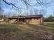 Brick single-story home featuring a covered porch and a well-maintained lawn at 222 Weldon Cir, Mount Holly, NC 28120